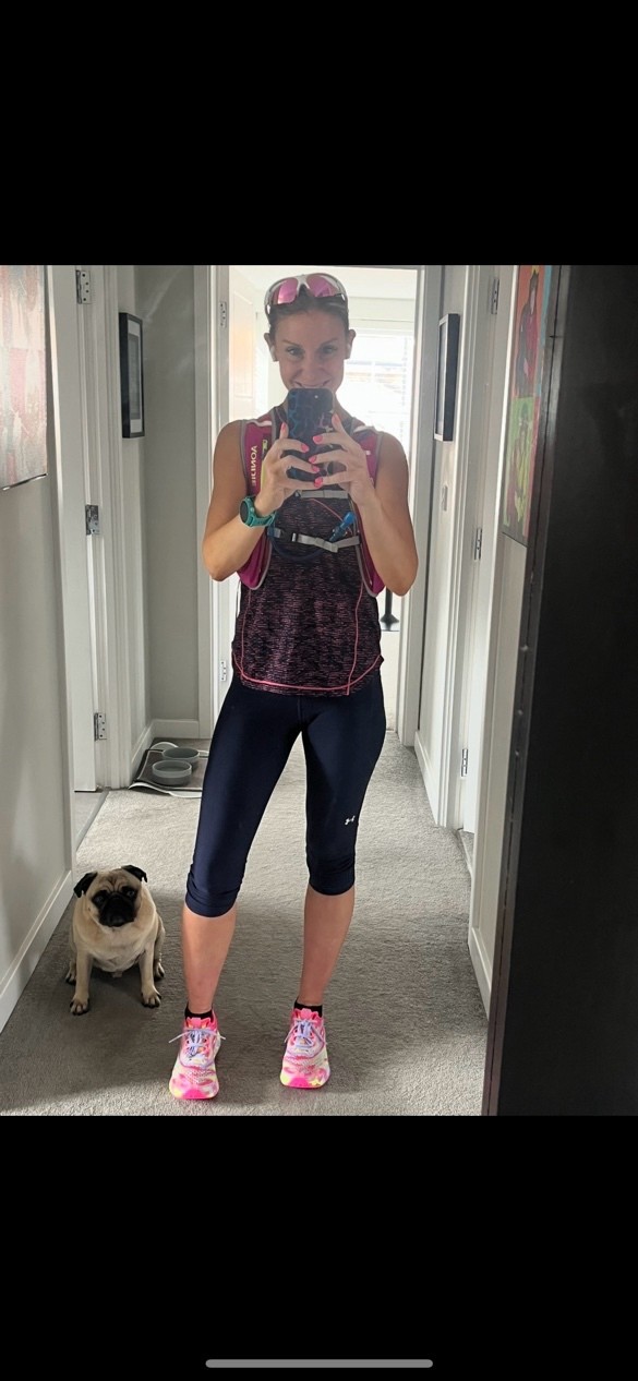 Liz in sports kit with her pug